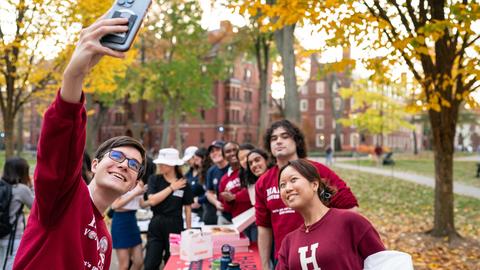 A HVC student taking a selfie with other students at a booth. 