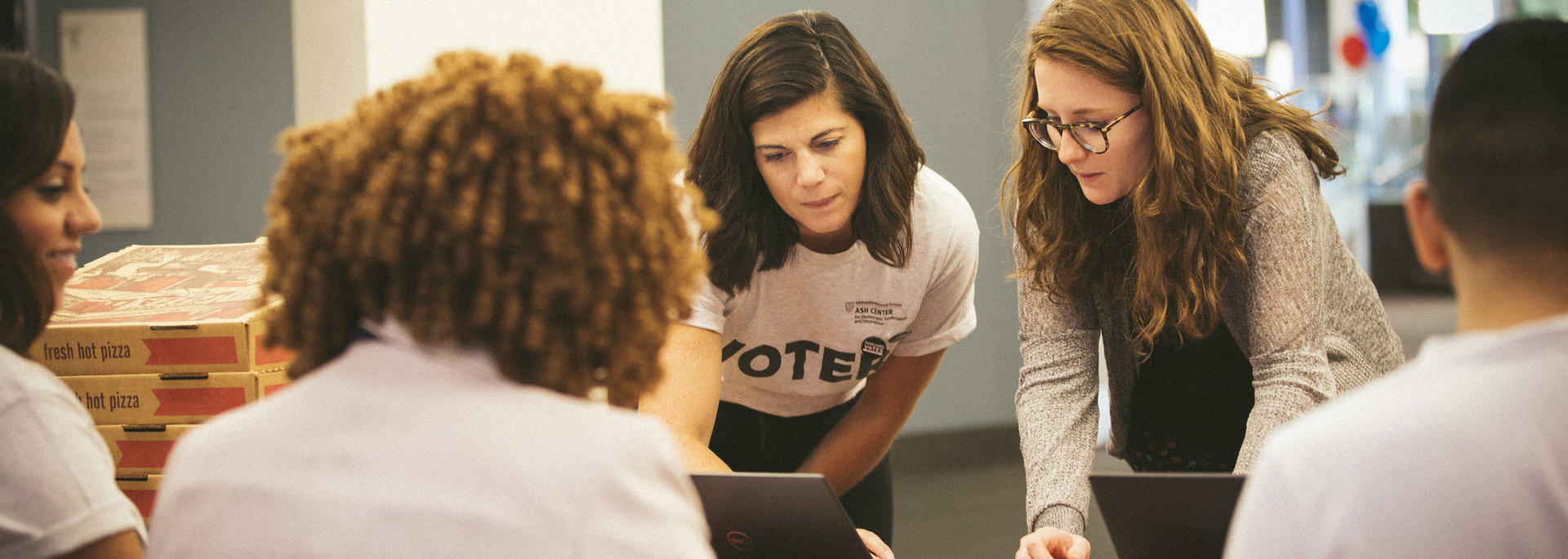 Harvard Votes Challenge team member helps a student register to vote